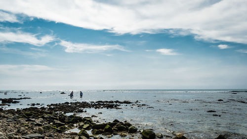 Scenic view of sea against cloudy sky