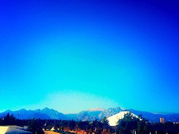 Scenic view of mountains against clear blue sky