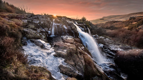 The loup of fintry waterfall on the river endrick at sunset 