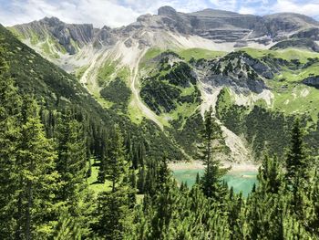 Panoramic view of trees and mountains against sky