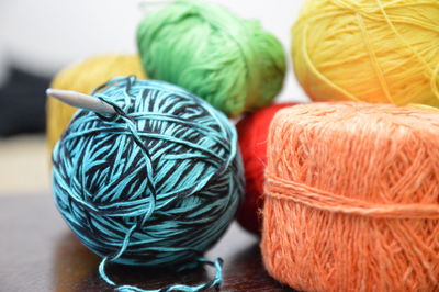 Close-up of multi colored wool balls on table