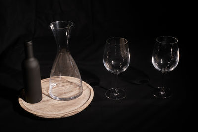 High angle view of wine glasses on table against black background