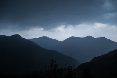 Scenic view of silhouette mountains against sky