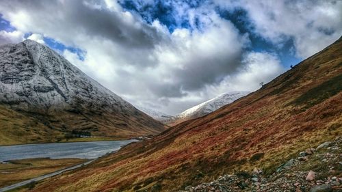 Scenic view of mountains against cloudy sky