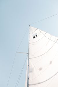 Low angle view of sailboat against clear sky