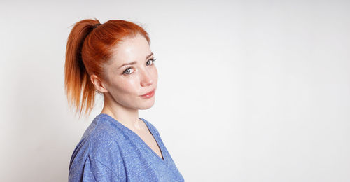 Young woman standing against white background