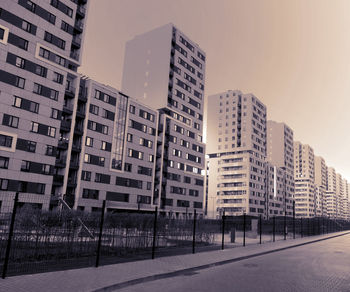 Low angle view of buildings against clear sky during winter