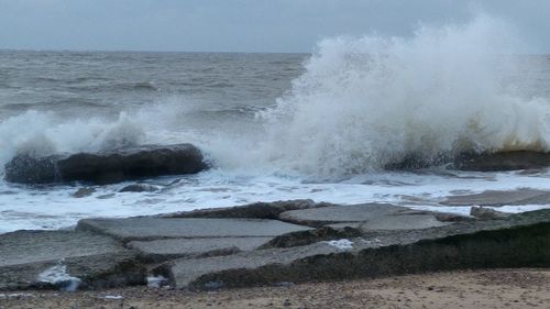 Waves splashing on rocks at beach