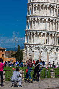 Group of people in front of historic building