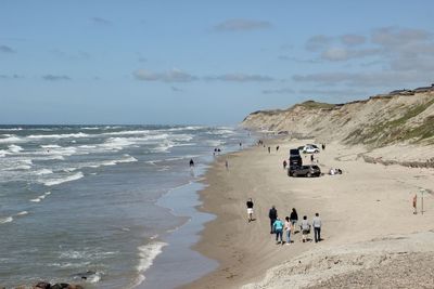 People on beach against sky