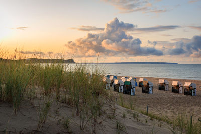 Scenic view of beach against sky during sunset