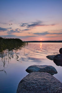 Scenic view of lake against sky during sunset