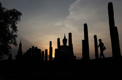 Low angle view of silhouette buddha statue