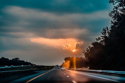 Driving on marked road at sunset