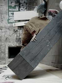 Close-up of woman standing against wall