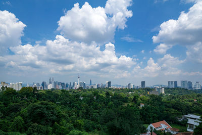 Panoramic view of trees and buildings against sky