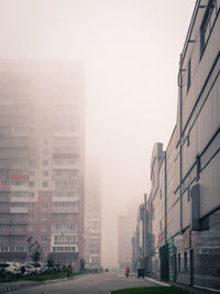 Empty road along buildings