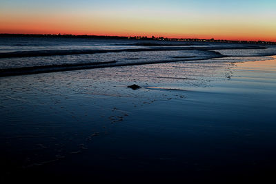 Scenic view of lake against sky during sunset