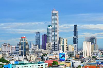 View of skyscrapers against cloudy sky