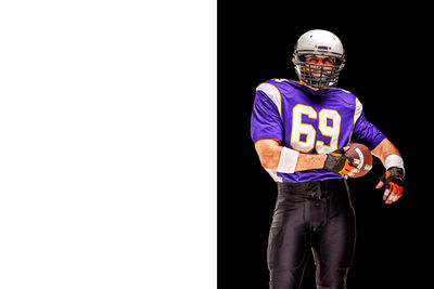 Man wearing mask against black background