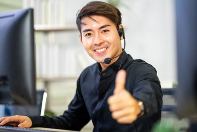 Portrait of smiling young man using mobile phone