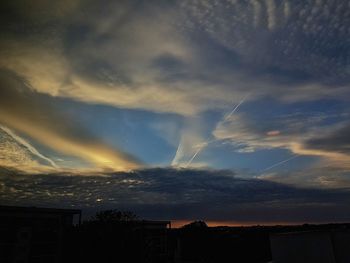 Cityscape against cloudy sky