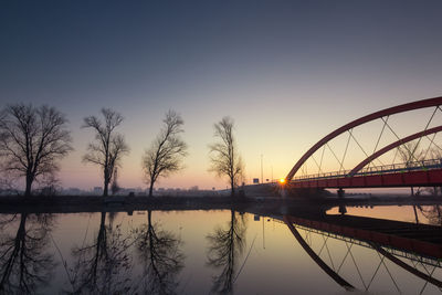 Modern bridge. the sun goes up behind the new bridge over the bosut river in vinkovci, croatia.