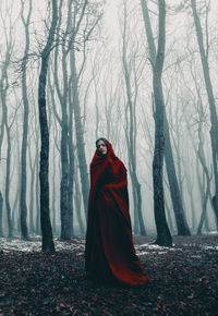 Young woman standing in forest