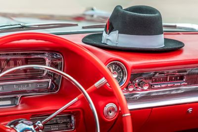 Close-up of hat on dashboard in red car