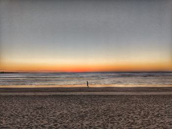 Scenic view of beach against sky during sunset