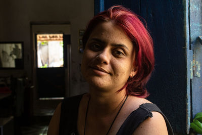 Portrait of woman with dyed hair at home