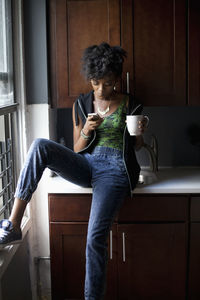 Woman drinking glass at home