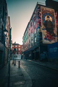 Street amidst buildings against sky in city