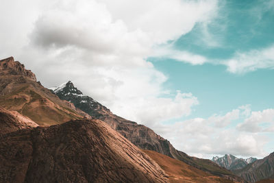 Scenic view of mountains against cloudy sky