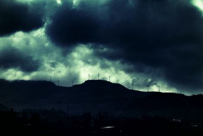 Scenic view of mountains against cloudy sky