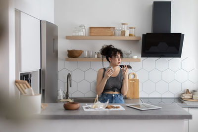 Woman sitting on table at home