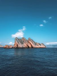 Scenic view of sea against blue sky