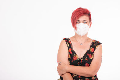 Portrait of woman standing against white background