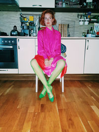 Woman sitting on chair at home