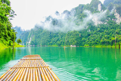 Scenic view of swimming pool by lake against sky