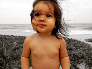 Portrait of shirtless boy at beach