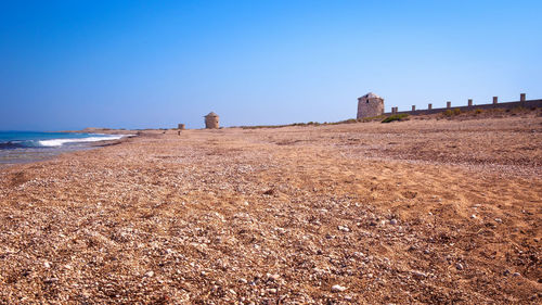 Scenic view of beach against clear sky