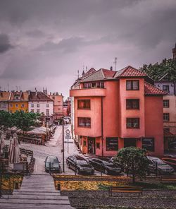 Street amidst houses and buildings against sky