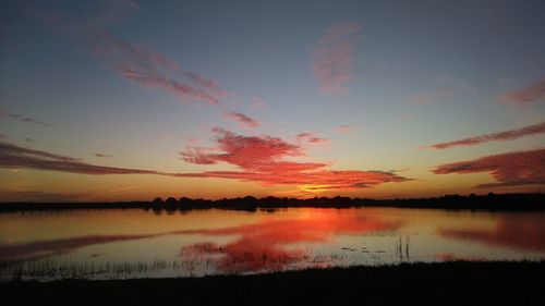 Scenic view of lake against romantic sky at sunset