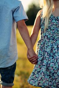 Midsection of couple holding hands