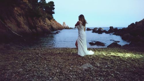 Young woman standing in water