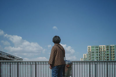 Rear view of man against buildings