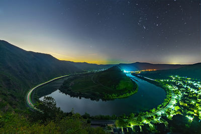 Aerial view of lake and mountains against sky at night