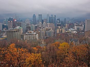 High angle view of buildings against sky during autumn