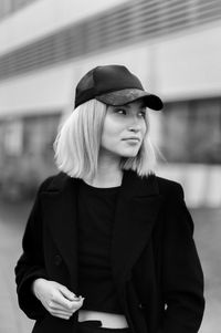 Portrait of woman wearing hat standing outdoors